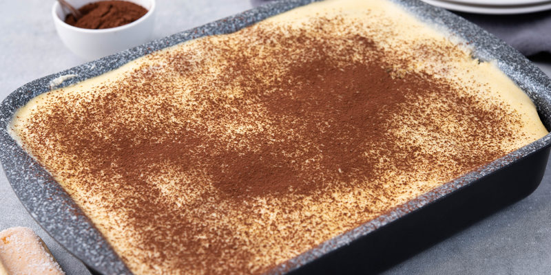 sprinkle cocoa powder on tiramisu