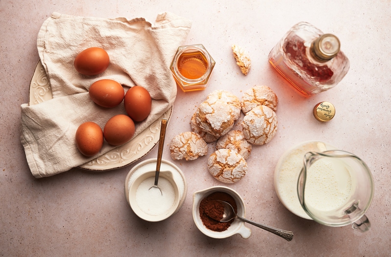 ingredients for bonet recipe: eggs, milk, amaretti cookies, cocoa, amaretto di saronno, sugar