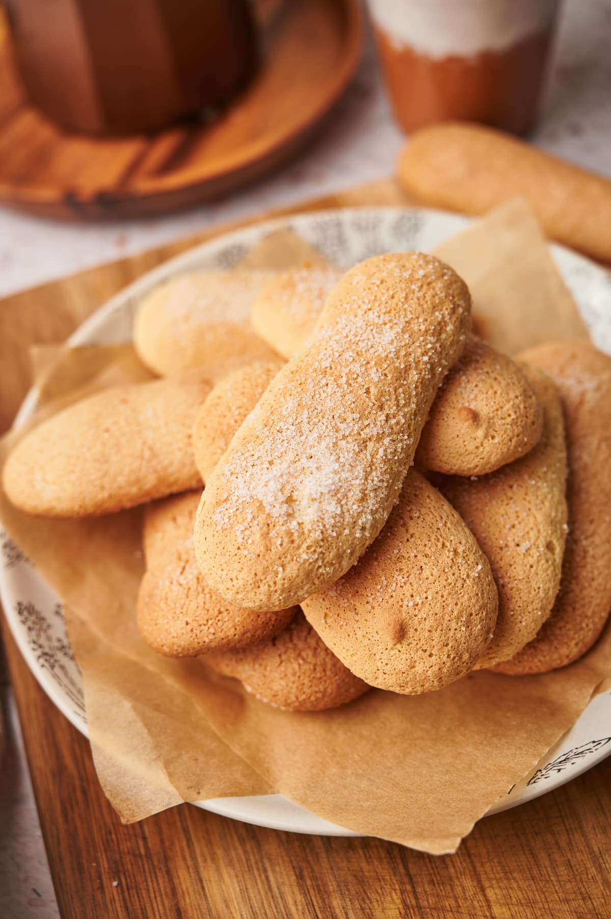 picture of homemade ladyfingers savoiardi cookies on a plate next to a coffee moka maker