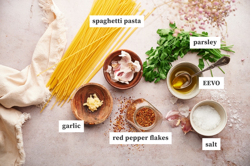 ingredients for making pasta aglio e olio on a table