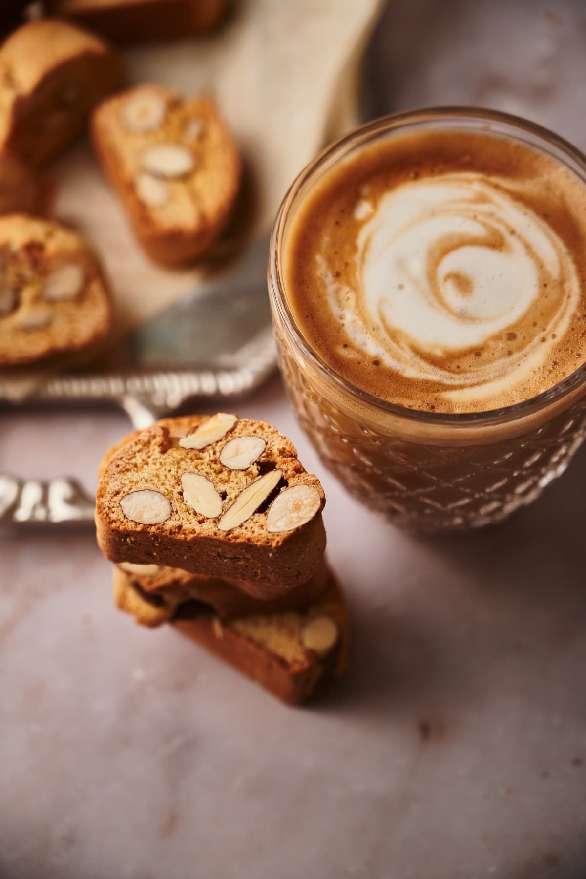 cantucci biscotti next to a cup of coffe with milk
