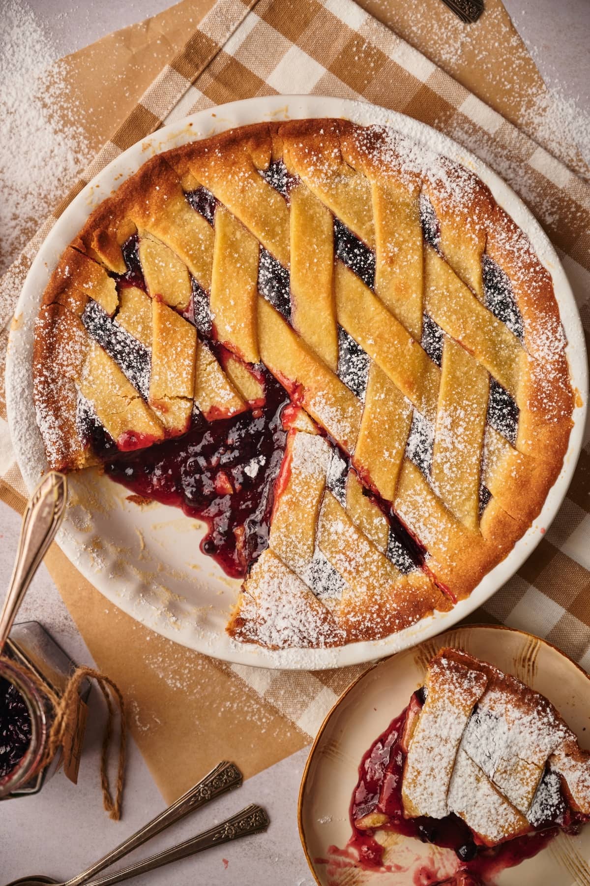 italian crostata with a slice of crostata on a serving plate