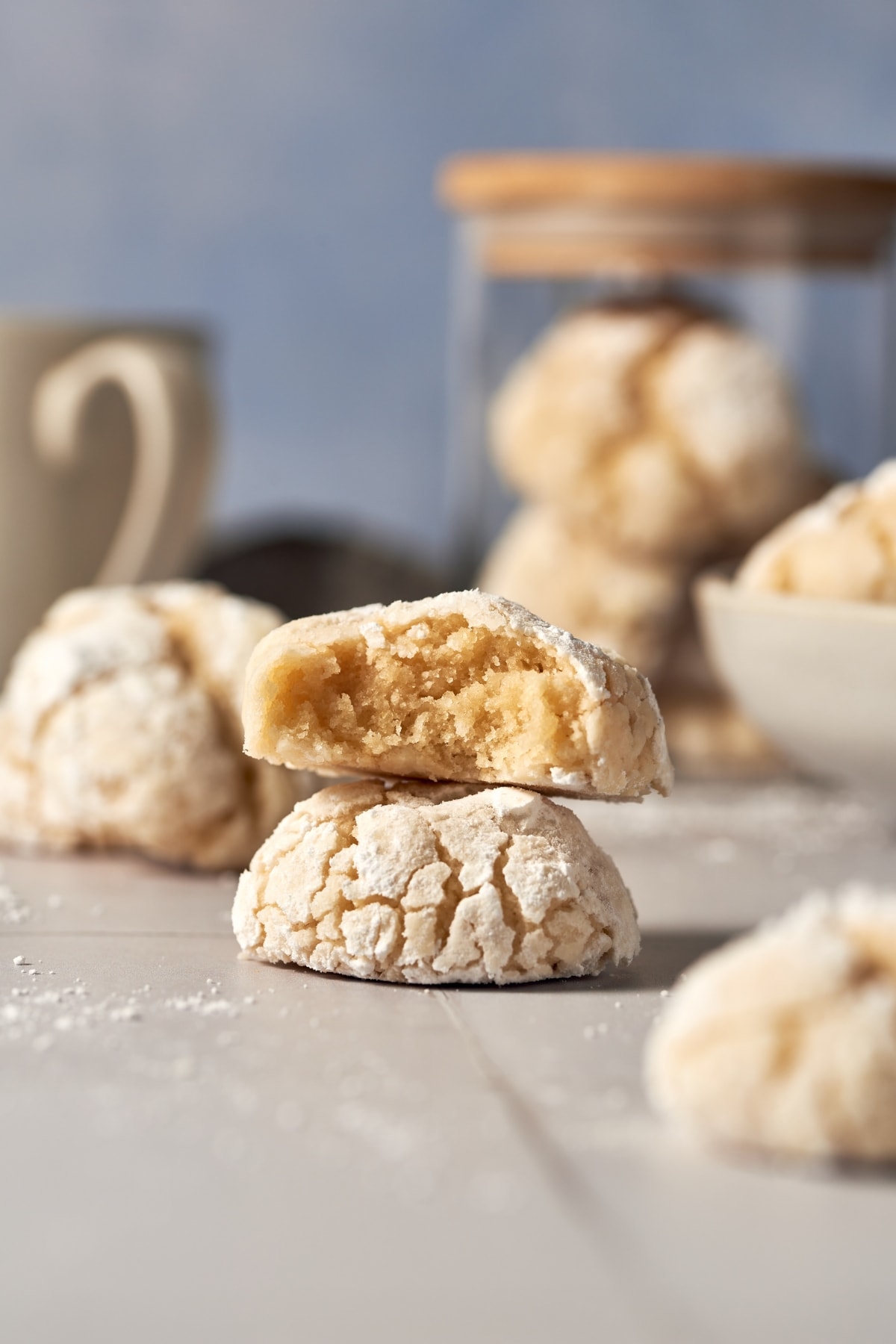 two italian almond cookies on top of each other. the one on top has a bite.