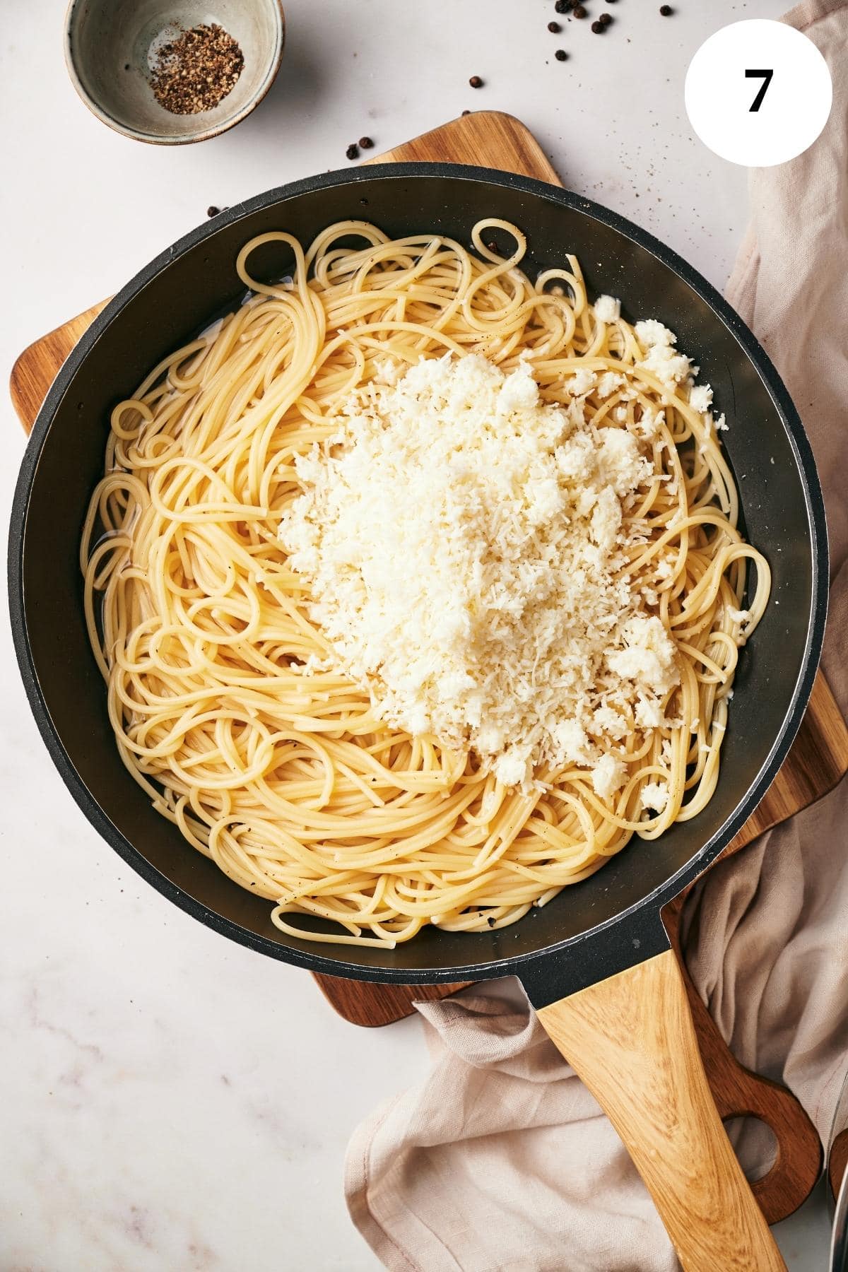pan of pasta with romano cheese on top