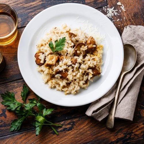 Risotto with porcini mushroom on wooden table